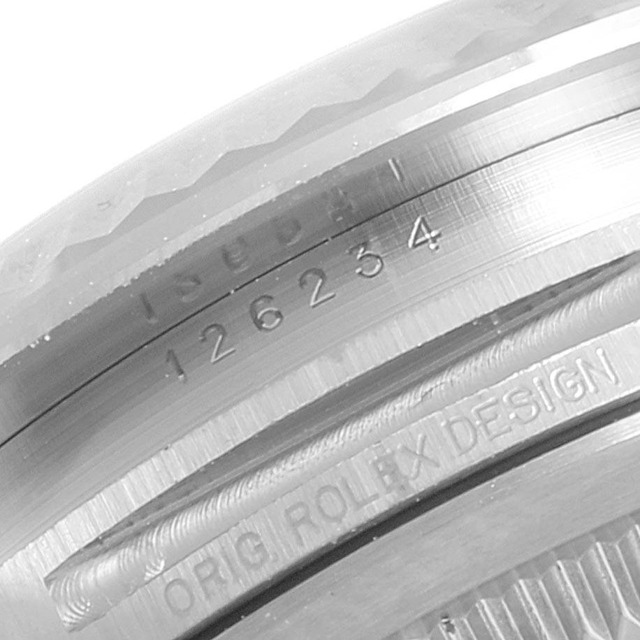 This close-up image shows the engraved model number and "ORIG ROLEX DESIGN" inscription on the side of a Rolex Datejust 126234 Men's Stainless Steel Blue Dial 126234 Men's Stainless Steel Blue Dial watch.