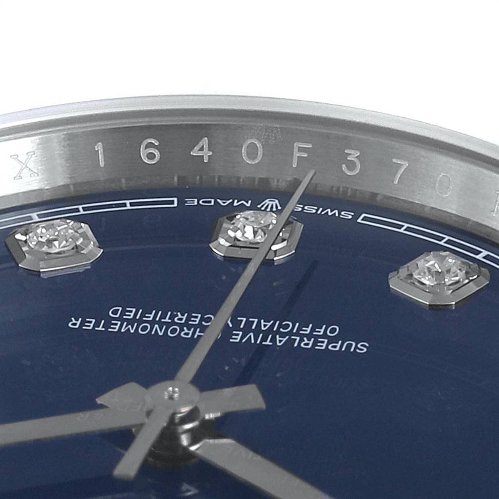The image shows a close-up of the dial and bezel, focusing on the inscriptions and diamond markers on a Rolex Datejust 126234 Men's Stainless Steel Blue Dial 126234 Men's Stainless Steel Blue Dial watch.