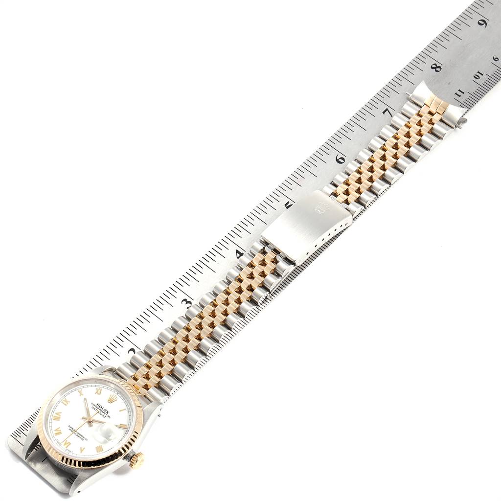 The image shows a full view of a Rolex Datejust 16233 Men's Steel and Gold (two tone) White Dial 16233 Men's Steel and Gold (two tone) White Dial watch with its bracelet laid out beside a ruler for measurement.