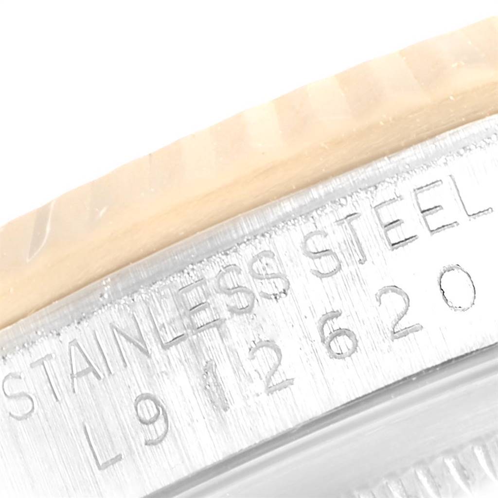 This image shows a close-up of the Rolex Datejust 16233 Men's Steel and Gold (two tone) White Dial 16233 Men's Steel and Gold (two tone) White Dial model's engraved stainless steel case and part of the bezel.