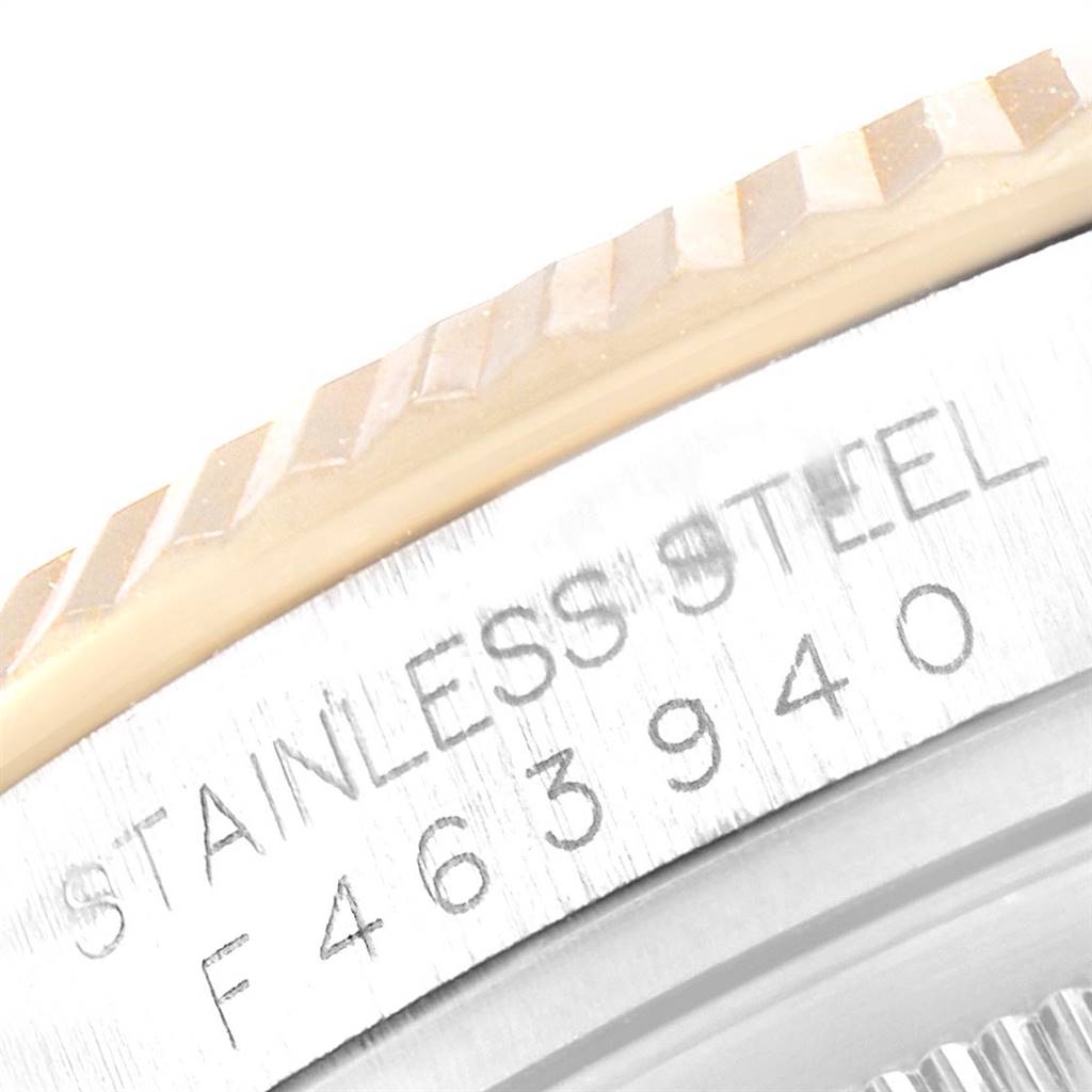 This image shows a close-up of the side bezel and case of the Rolex Datejust 116233 Men's Stainless Steel Grey Dial 116233 Men's Stainless Steel Grey Dial watch, highlighting the "STAINLESS STEEL" engraving and serial number.