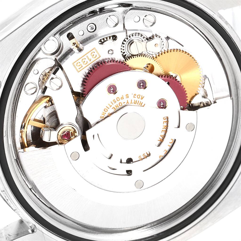 This is an internal view of the Rolex Datejust 116233 Men's Stainless Steel Grey Dial 116233 Men's Stainless Steel Grey Dial watch, showing the intricate components and gears of the movement mechanism.