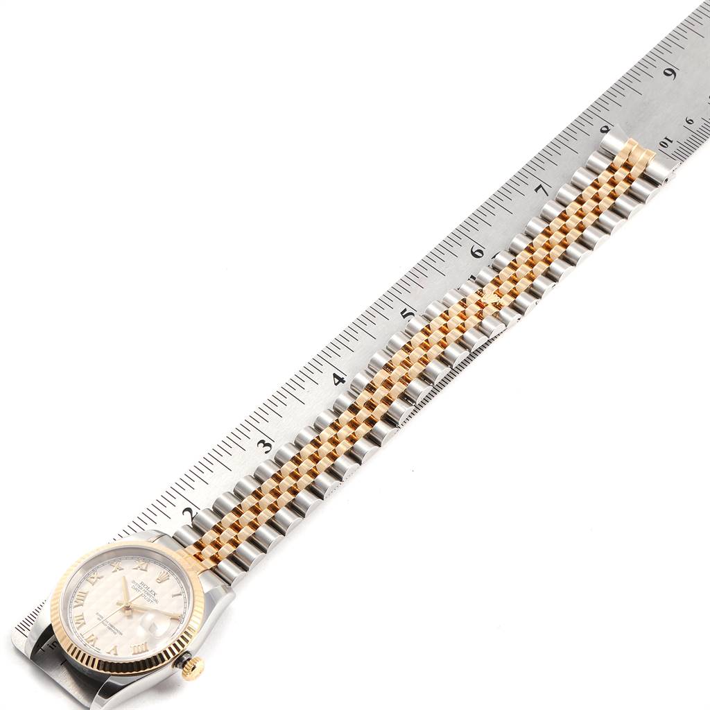 The Rolex Datejust 116233 Men's Steel and Gold (two tone) Beige Dial 116233 Men's Steel and Gold (two tone) Beige Dial watch is shown in a flat position with a focus on the dial and bracelet, measured against a ruler.