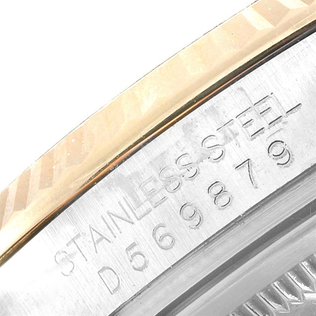 This is a close-up image of the serial number and fluted bezel of a Rolex Datejust 116233 Men's Steel and Gold (two tone) Beige Dial 116233 Men's Steel and Gold (two tone) Beige Dial watch.