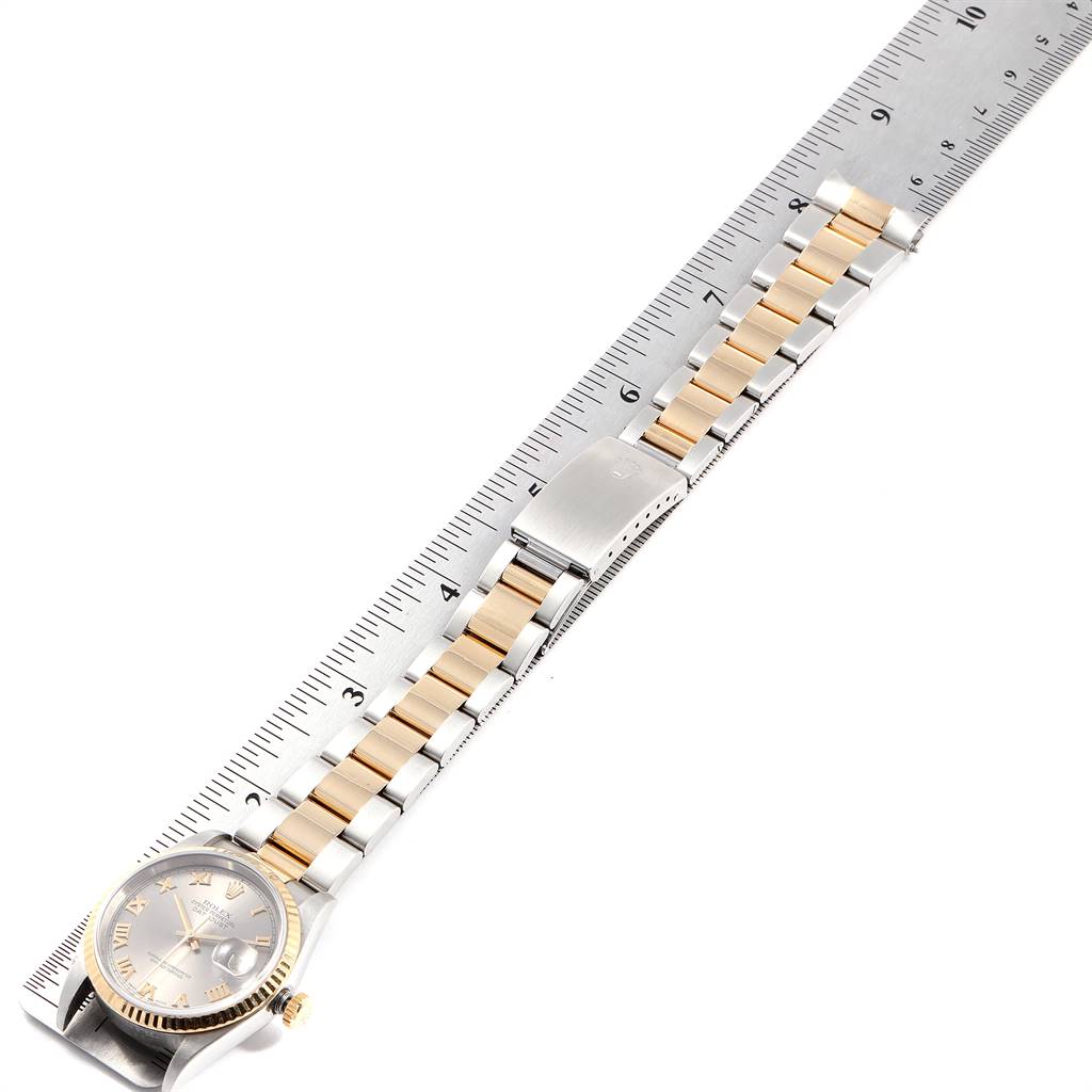 The image shows a Rolex Datejust 16233 Men
s Steel and Gold (two tone) Grey Dial 16233 Men
s Steel and Gold (two tone) Grey Dial watch from a top-angle, displaying the face, bezel, and bracelet with a ruler beside it for scale.