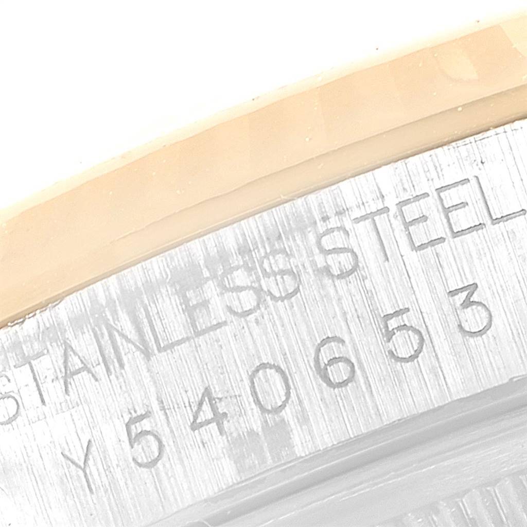 This close-up image shows the serial number and part of the stainless steel casing for the Rolex Datejust 16233 Men
s Steel and Gold (two tone) Grey Dial 16233 Men
s Steel and Gold (two tone) Grey Dial watch.