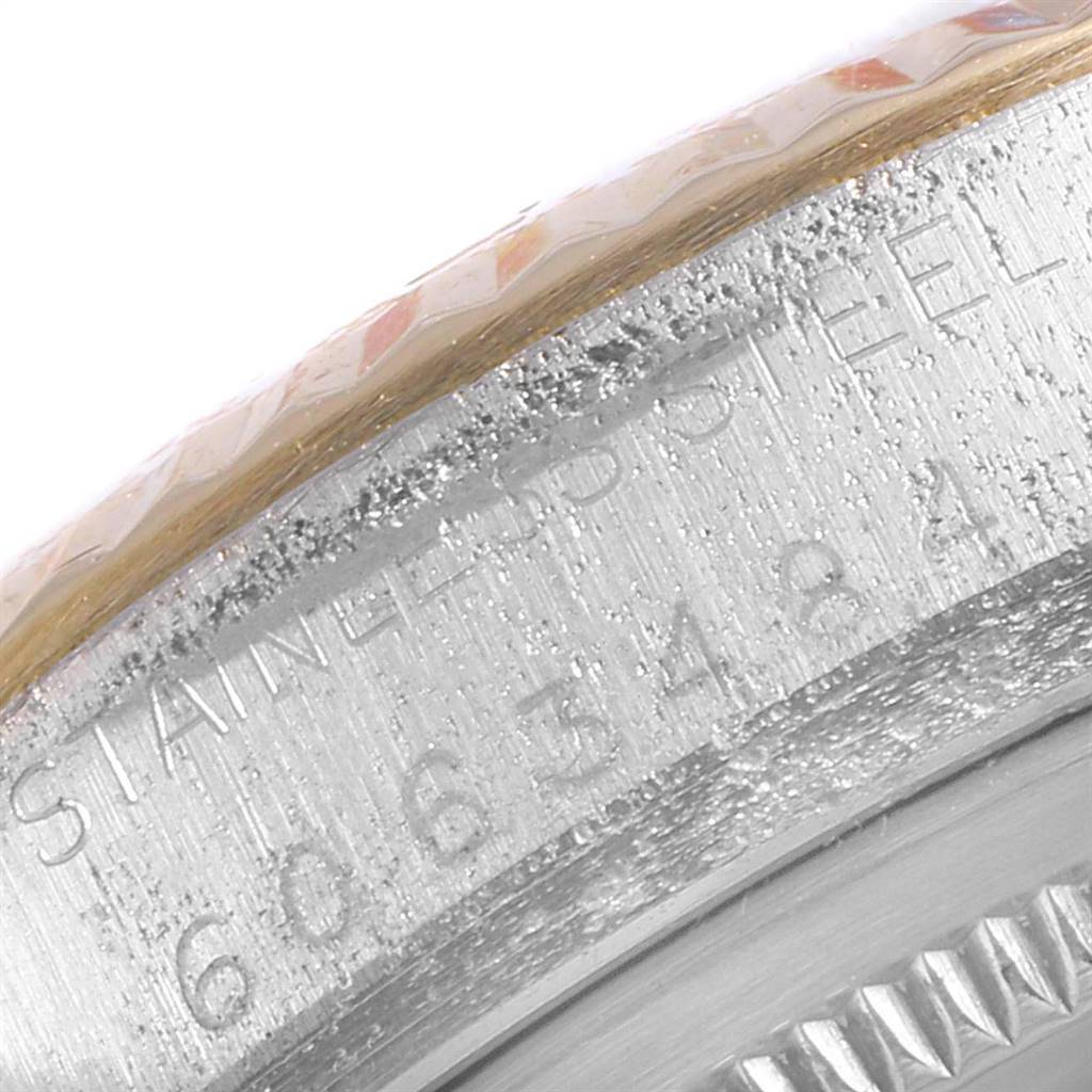 This close-up image shows the serial number and part of the fluted bezel of a Rolex Datejust 16013 Men
s Stainless Steel Champagne Dial 16013 Men
s Stainless Steel Champagne Dial watch.