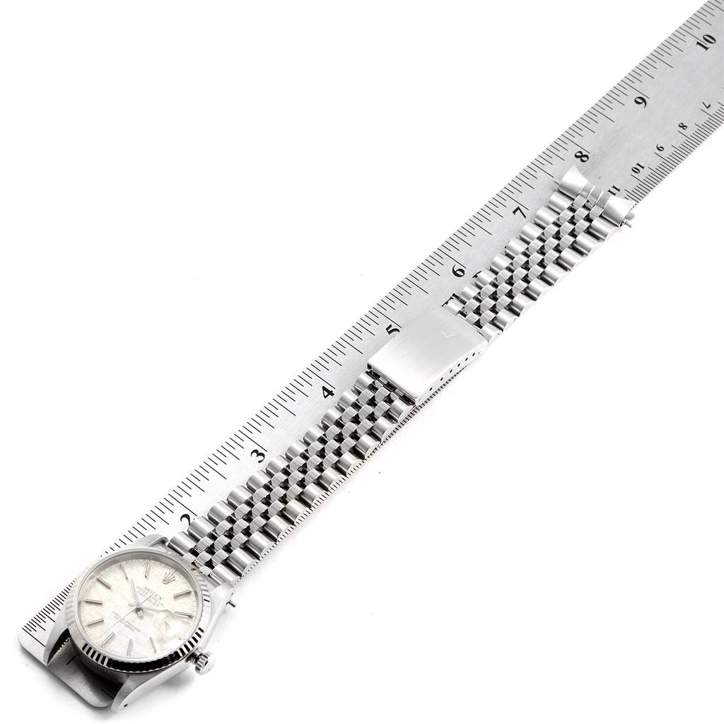 The image shows a Rolex Datejust 16234 Men's Stainless Steel Silver Dial 16234 Men's Stainless Steel Silver Dial watch at a slight angle, highlighting the face and stainless steel bracelet, with a ruler for measuring length.