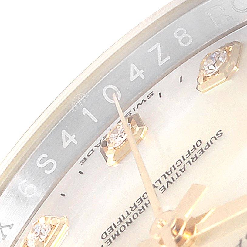 This image shows a close-up of the dial and hands of a Rolex Datejust 116243 Men
s Steel and Gold (two tone) Mother of Pearl Dial 116243 Men
s Steel and Gold (two tone) Mother of Pearl Dial watch, highlighting its markers and text detail.