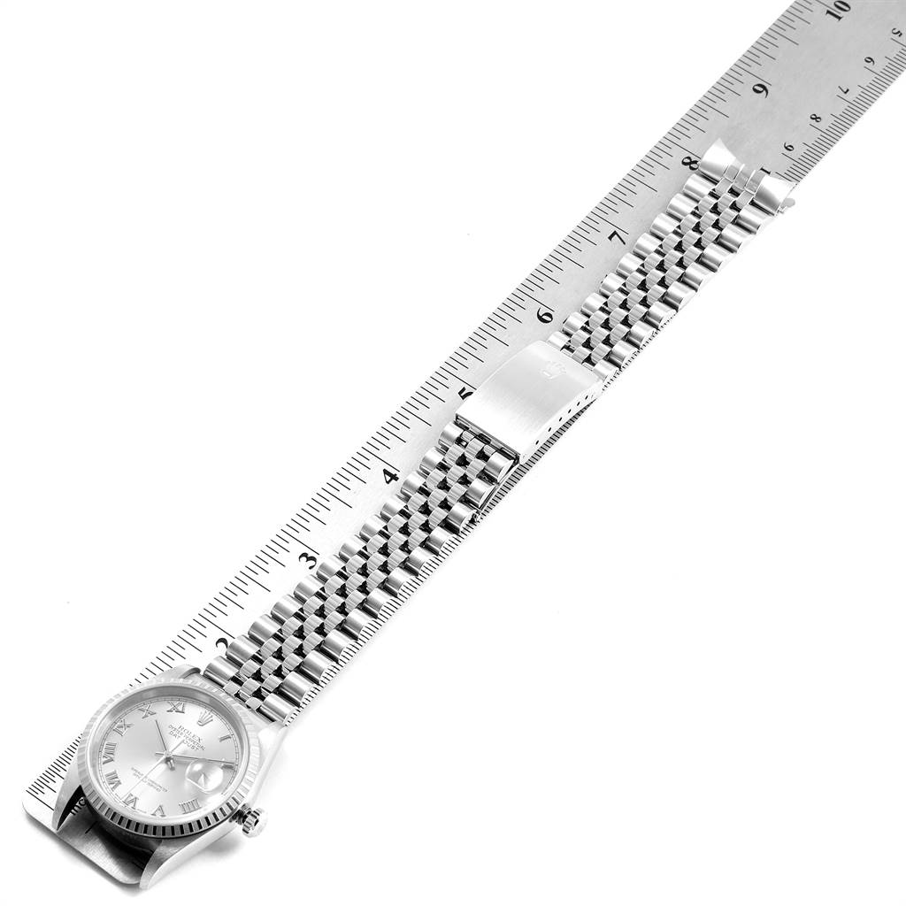 The image shows a Rolex Datejust 16220 Men's Stainless Steel Silver Dial 16220 Men's Stainless Steel Silver Dial watch from a top-down angle with its face, bracelet, and clasp visible, alongside a ruler.