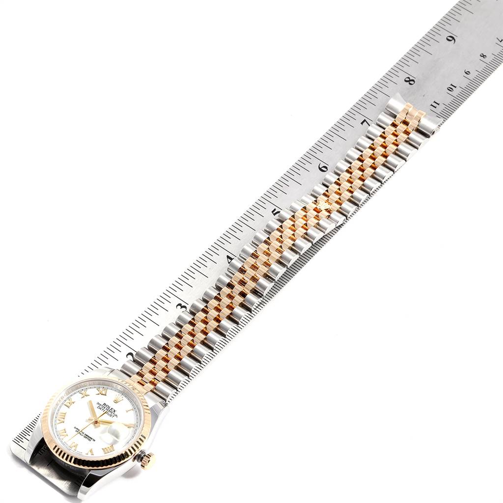 The image shows a Rolex Datejust 25825 Men's Stainless Steel White Dial 25825 Men's Stainless Steel White Dial watch laid flat next to a ruler, displaying the face, bezel, and bracelet.