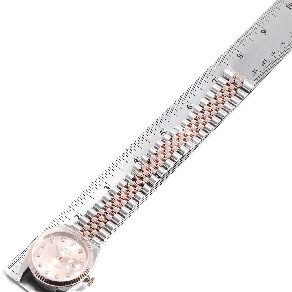 This image shows a Rolex Datejust 116231 Men's Steel and Gold (two tone) Pink Dial 116231 Men's Steel and Gold (two tone) Pink Dial watch lying flat with its band aligned along a ruler for measurement.