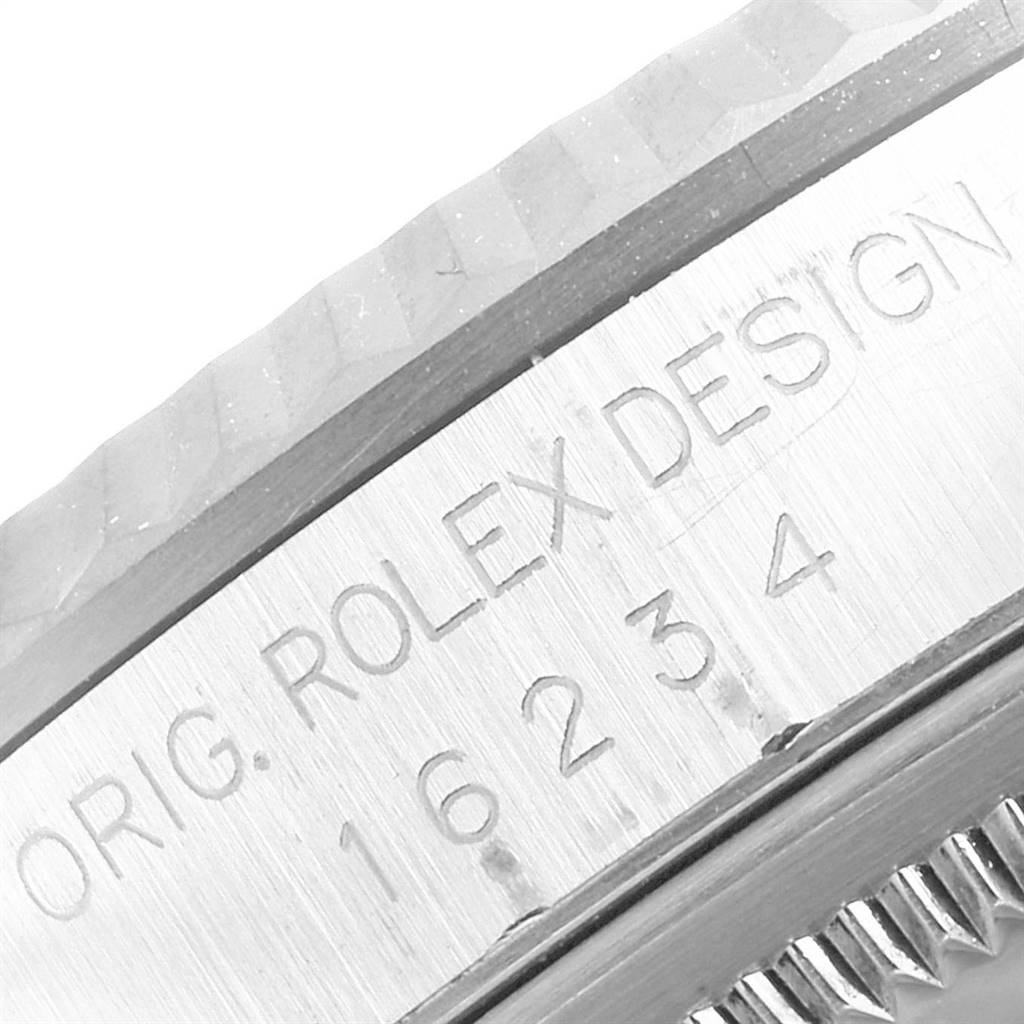 This image shows the side engraving of the Rolex Datejust 16234 Men's Stainless Steel Mother of Pearl Dial 16234 Men's Stainless Steel Mother of Pearl Dial watch case, displaying the model number and "ORIG. ROLEX DESIGN".