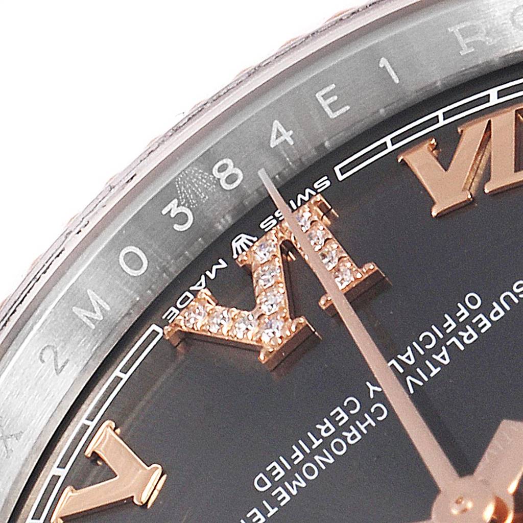 This close-up image of a Rolex Datejust 126231 Men's Steel and Gold (two tone) Grey Dial 126231 Men's Steel and Gold (two tone) Grey Dial watch shows the bezel, part of the dial, and the diamond-encrusted Roman numerals.