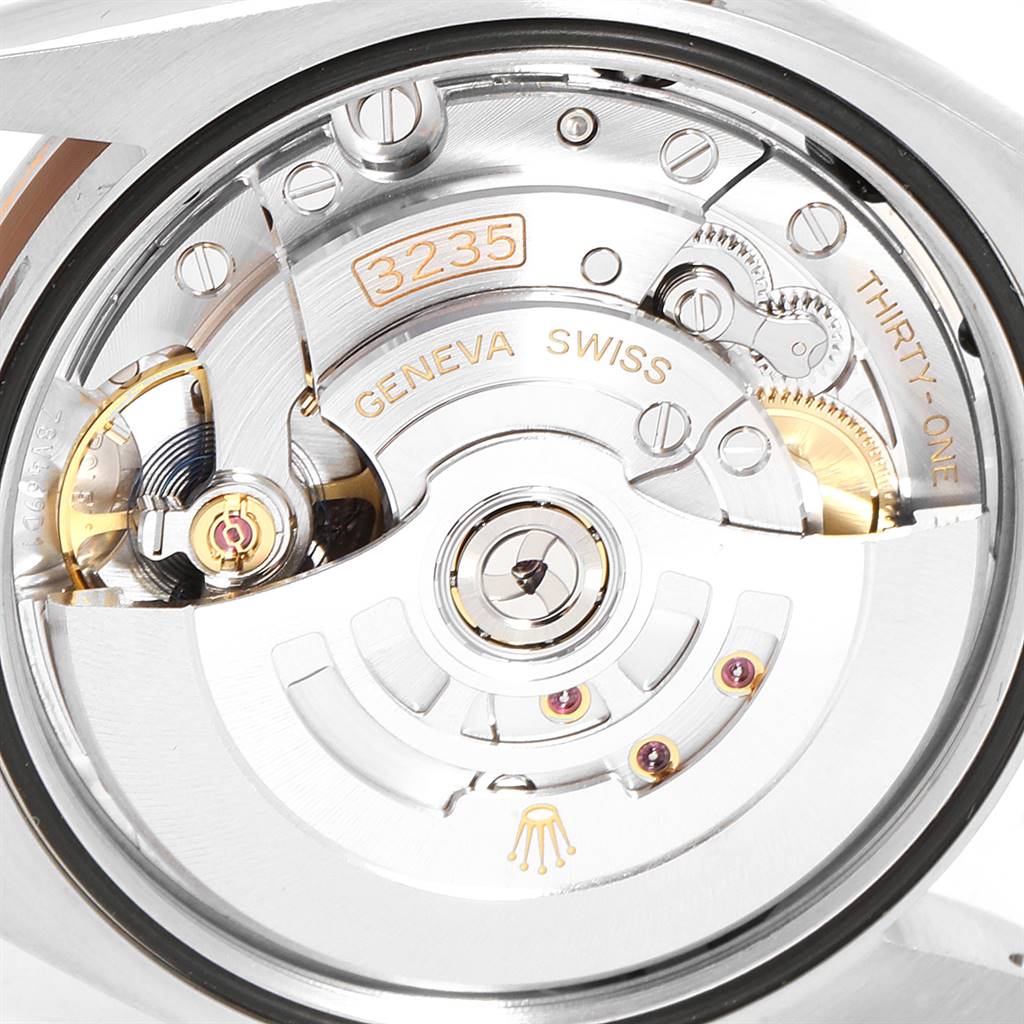 The image shows the movement mechanism of a Rolex Datejust 126231 Men's Steel and Gold (two tone) Grey Dial 126231 Men's Steel and Gold (two tone) Grey Dial, featuring the self-winding rotor and various internal components.