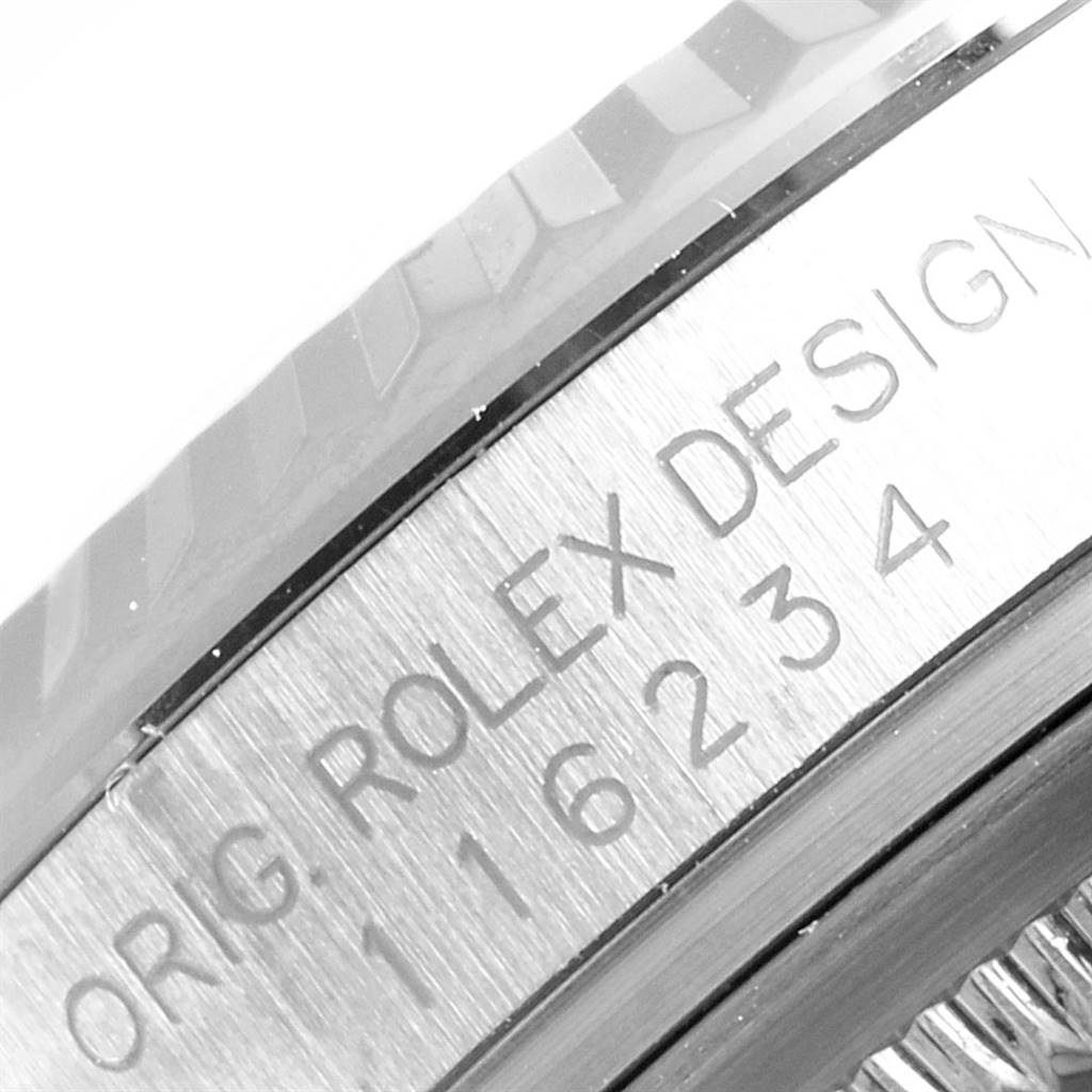 The image shows a close-up of the bezel and engraved text on the casing of a Rolex Datejust 116234 Men's Stainless Steel Blue Dial 116234 Men's Stainless Steel Blue Dial watch.