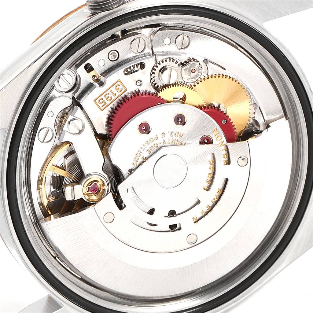 The image shows the intricate inner mechanism of the Rolex Datejust 16233 Men's Steel and Gold (two tone) Champagne Dial 16233 Men's Steel and Gold (two tone) Champagne Dial watch from a close-up, back-side angle.