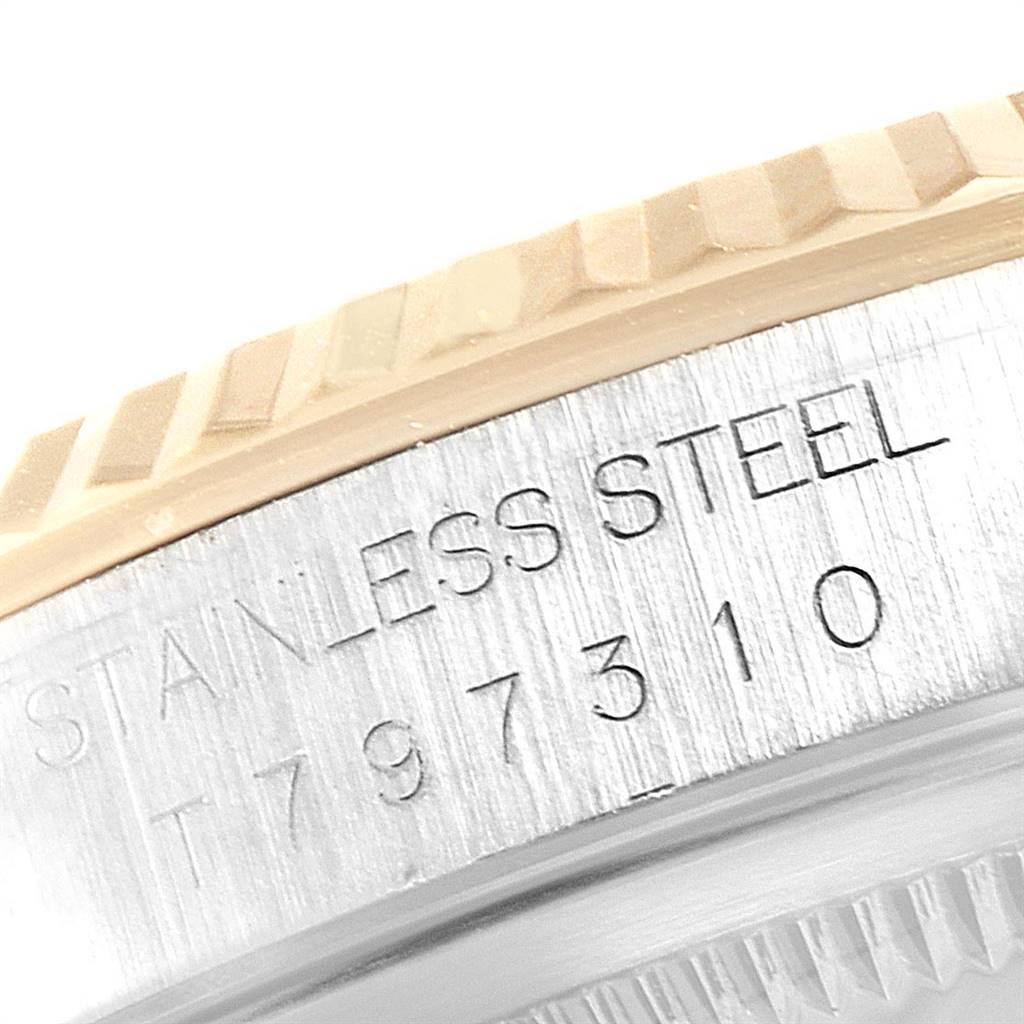 The image shows a close-up of the serial number and part of the bezel of a Rolex Datejust 16233 Men's Steel and Gold (two tone) Champagne Dial 16233 Men's Steel and Gold (two tone) Champagne Dial watch.