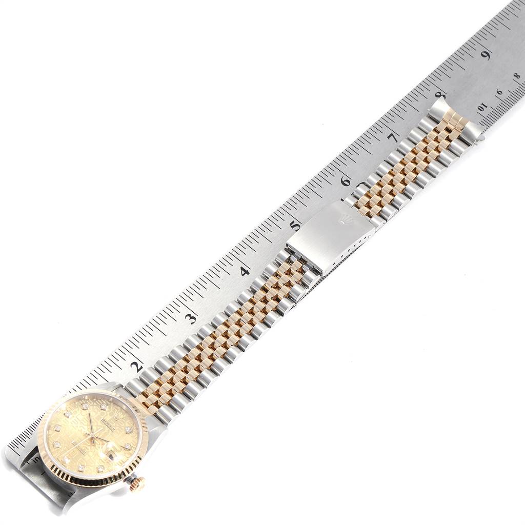 The image shows a Rolex Datejust 16233 Men's Steel and Gold (two tone) Champagne Dial 16233 Men's Steel and Gold (two tone) Champagne Dial watch laid flat next to a ruler, displaying its face and two-tone bracelet.