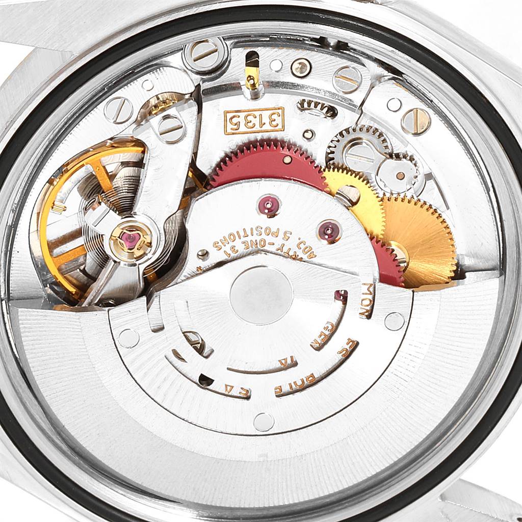 This is a close-up view of the internal mechanics of a Rolex Datejust 16233 Men's Steel and Gold (two tone) Champagne Dial 16233 Men's Steel and Gold (two tone) Champagne Dial watch, featuring gears and the movement.