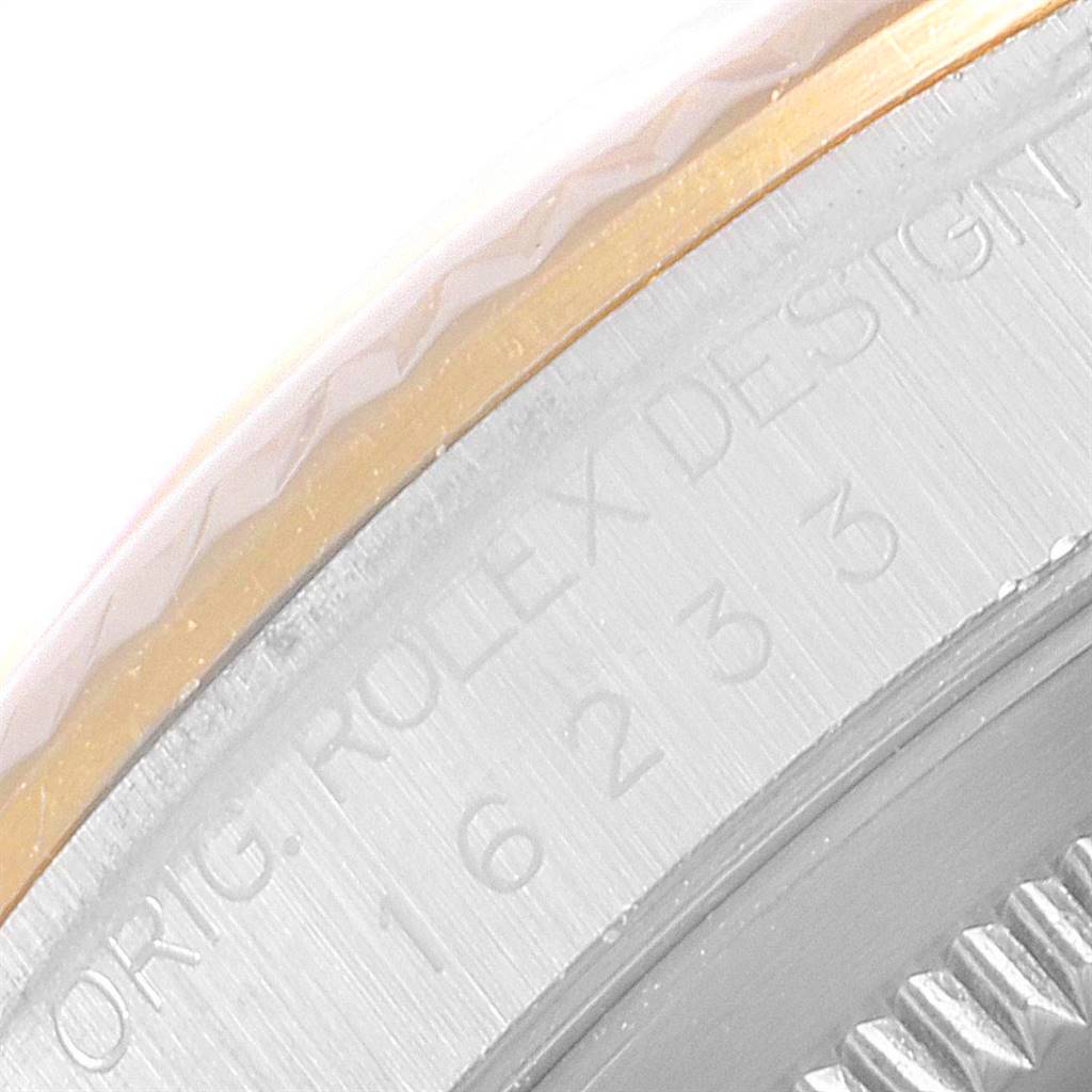 This image shows a close-up of the side engraving and bezel of a Rolex Datejust 16233 Men's Steel and Gold (two tone) Beige Dial 16233 Men's Steel and Gold (two tone) Beige Dial watch.