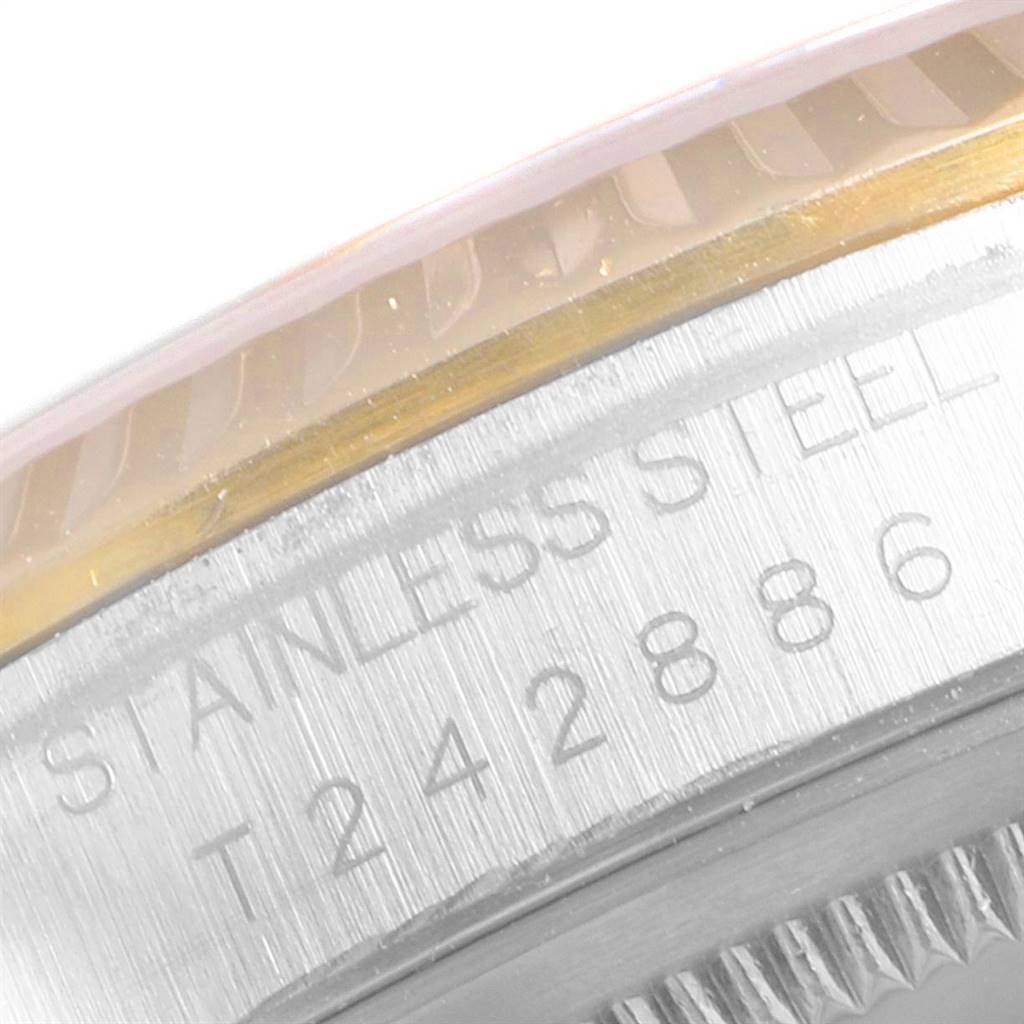 The image shows a close-up of the Rolex Datejust 16233 Men's Steel and Gold (two tone) Beige Dial 16233 Men's Steel and Gold (two tone) Beige Dial model's stainless steel case and part of its bezel.