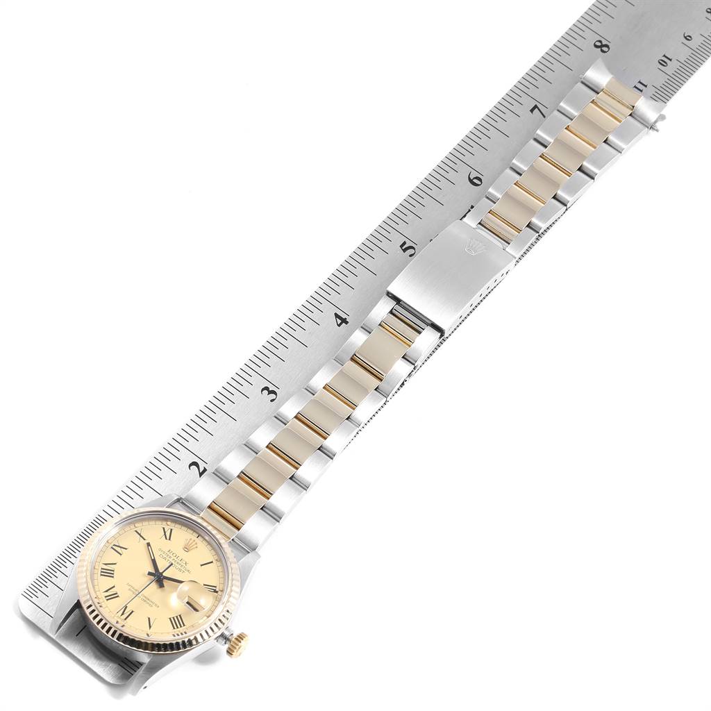 This image shows the face and band of a Vintage Collection Rolex watch, placed next to a ruler for measurement.