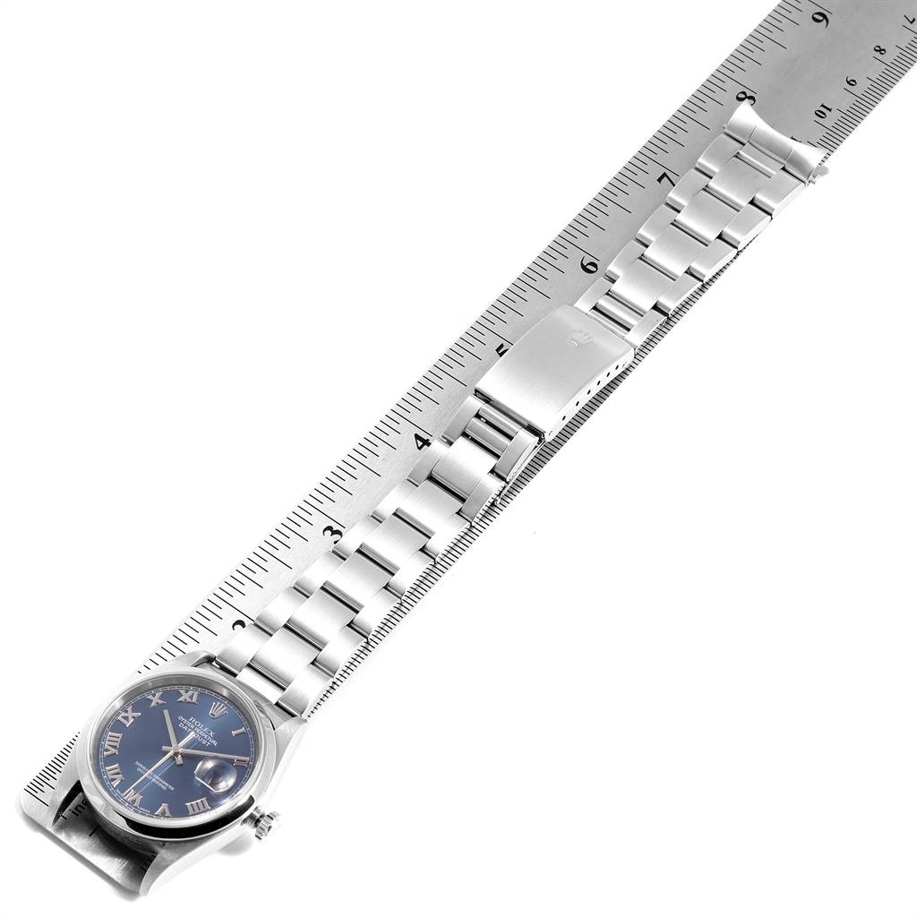 The image shows a Rolex Datejust 16200 Men's Stainless Steel Blue Dial 16200 Men's Stainless Steel Blue Dial watch laid flat against a ruler, displaying the face, bezel, and entire metal bracelet.