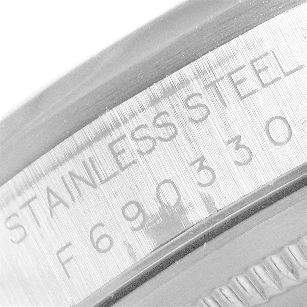 This close-up image shows the engraved serial number and "STAINLESS STEEL" marking on the side of the Rolex Datejust 16200 Men's Stainless Steel Blue Dial 16200 Men's Stainless Steel Blue Dial watch case.
