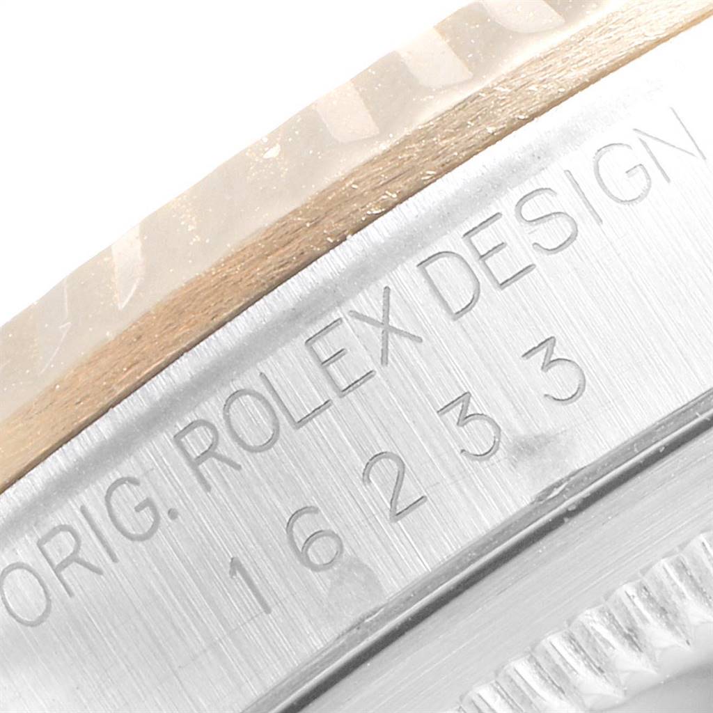 This close-up image shows the engraved serial number and bezel of a Rolex Datejust 16233 Men's Steel and Gold (two tone) Silver Dial 16233 Men's Steel and Gold (two tone) Silver Dial watch.