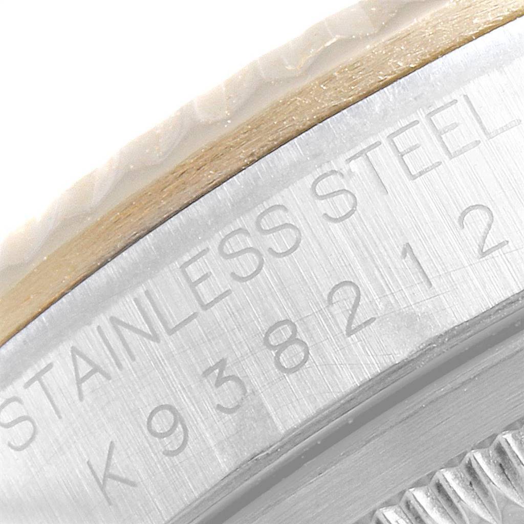 This close-up shows the Rolex Datejust 16233 Men's Steel and Gold (two tone) Silver Dial 16233 Men's Steel and Gold (two tone) Silver Dial's stainless steel case with part of the model and serial number engraved.