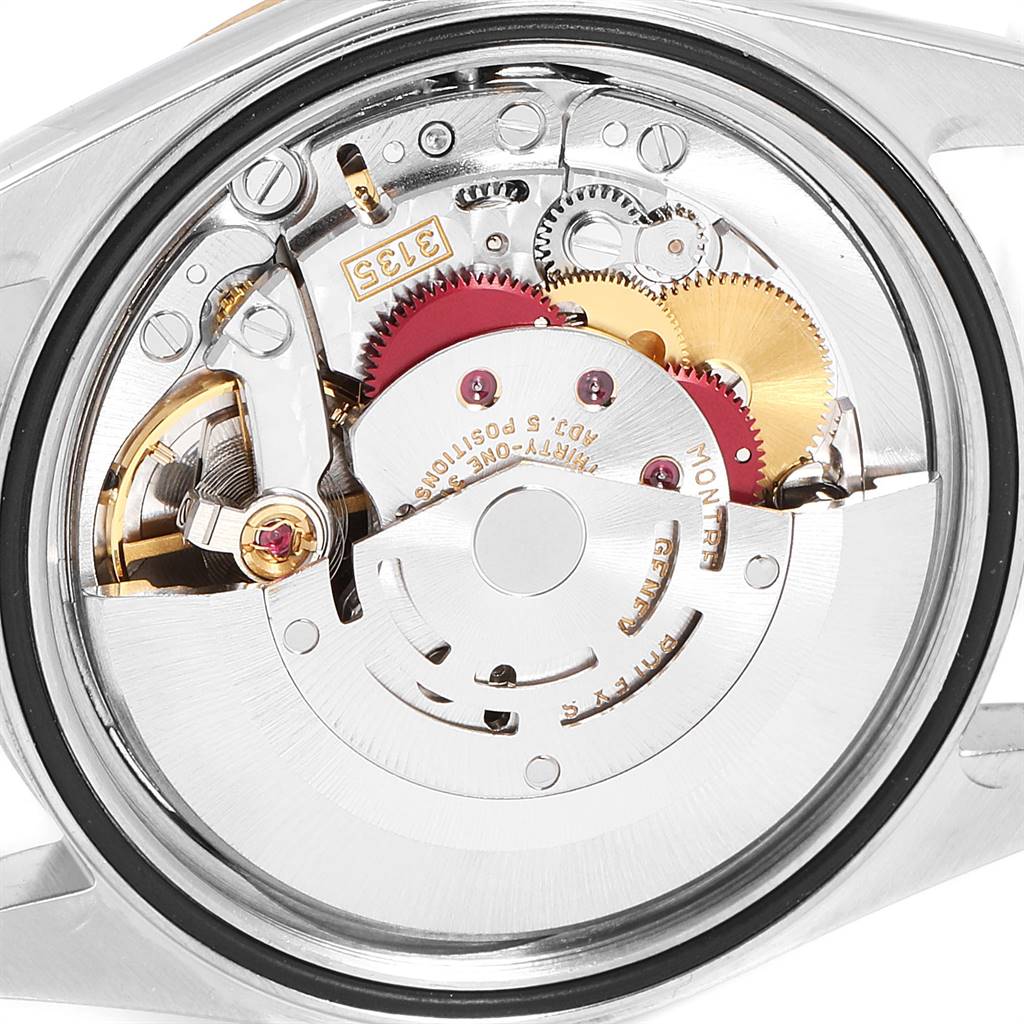 This image shows the inner mechanical movement of a Rolex Datejust 16233 Men's Steel and Gold (two tone) Silver Dial 16233 Men's Steel and Gold (two tone) Silver Dial watch from the back, revealing gears and components.