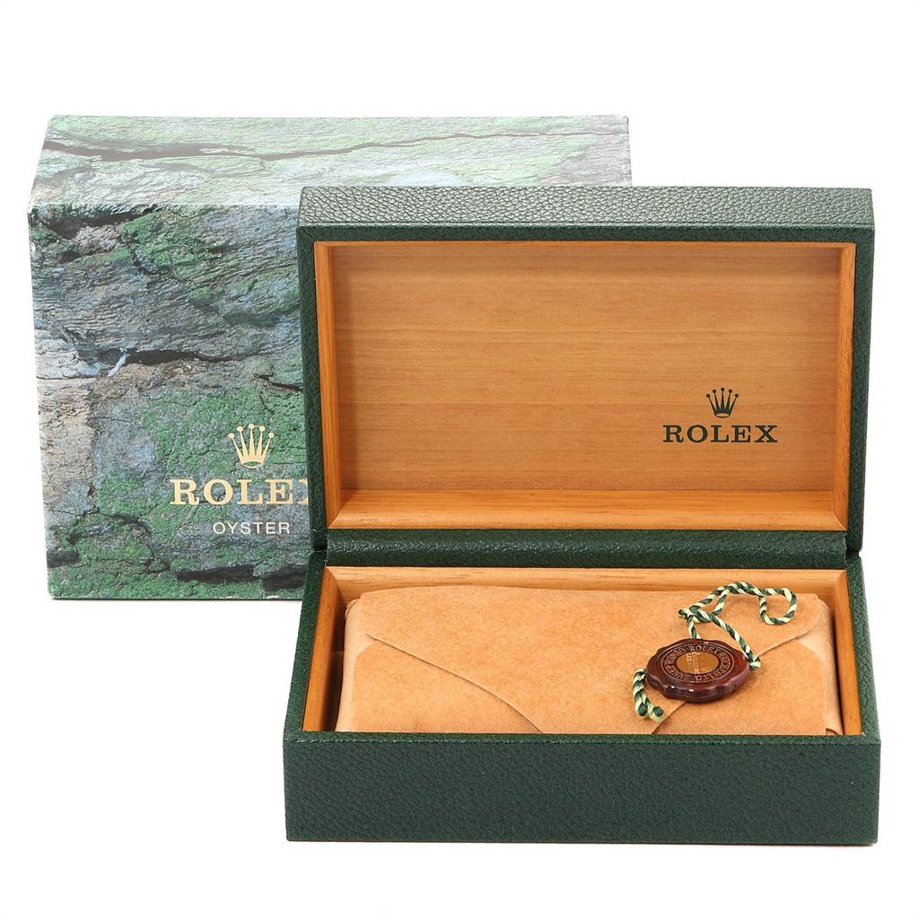 This image shows the packaging for a Rolex Datejust 16233 Men's Steel and Gold (two tone) Silver Dial 16233 Men's Steel and Gold (two tone) Silver Dial watch, including the green outer box, inner box, and a tag.