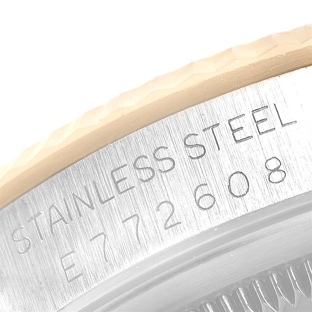 The close-up image shows a portion of the case side of a Rolex Datejust 16233 Men
s Steel and Gold (two tone) Champagne Dial 16233 Men
s Steel and Gold (two tone) Champagne Dial watch, highlighting the stainless steel engraving and serial number.