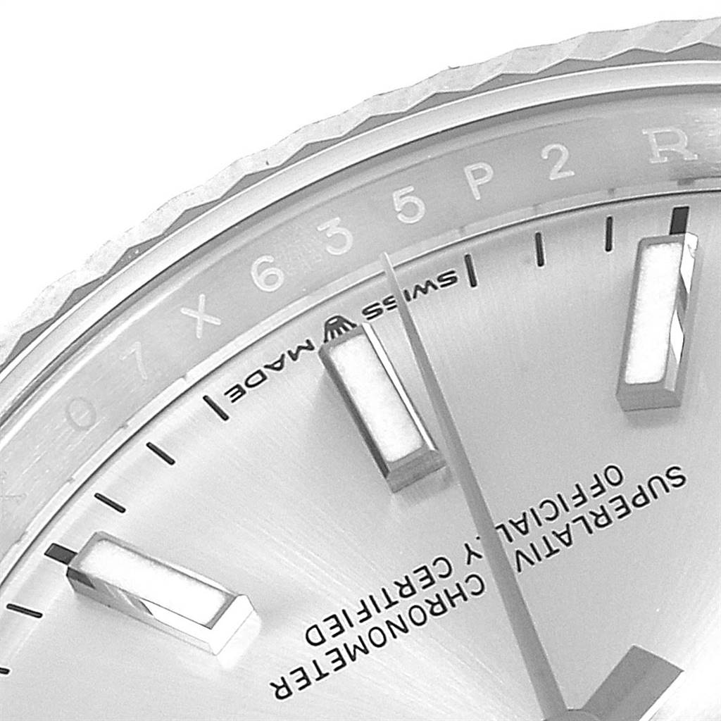 This close-up image of a Rolex Datejust 126234 Men's Stainless Steel Silver Dial 126234 Men's Stainless Steel Silver Dial watch showcases part of the dial, the indices, hands, and the "Swiss Made" labeling.
