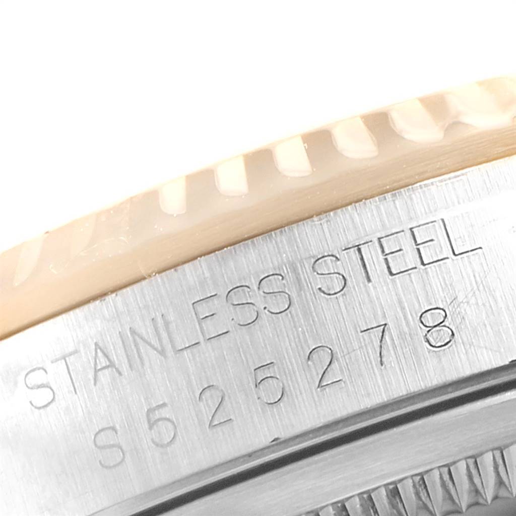 The image shows a close-up of the stainless steel bezel and case of a Rolex Datejust 16233 Men's Steel and Gold (two tone) Blue Dial 16233 Men's Steel and Gold (two tone) Blue Dial watch.