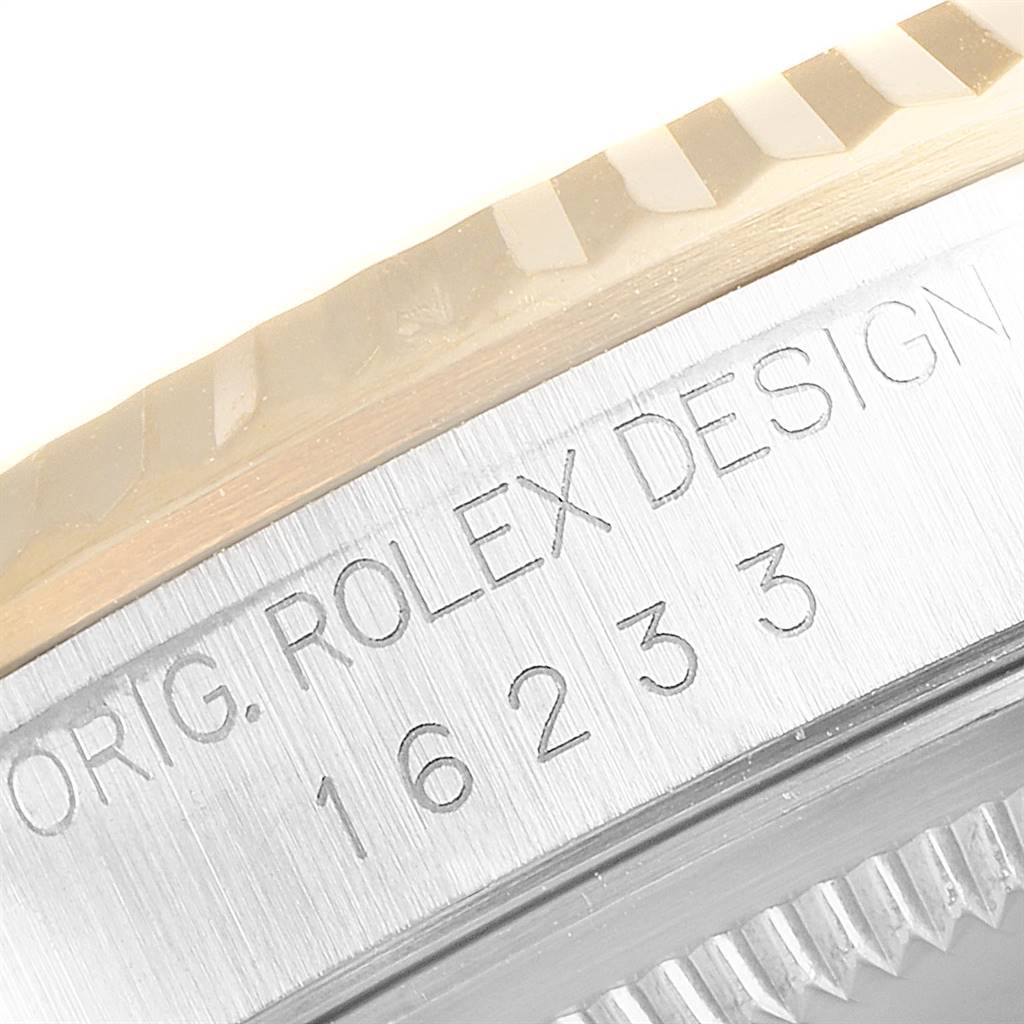 This close-up image shows the engraved text and fluted bezel of a Rolex Datejust 16233 Men
s Steel and Gold (two tone) Champagne Dial 16233 Men
s Steel and Gold (two tone) Champagne Dial watch.