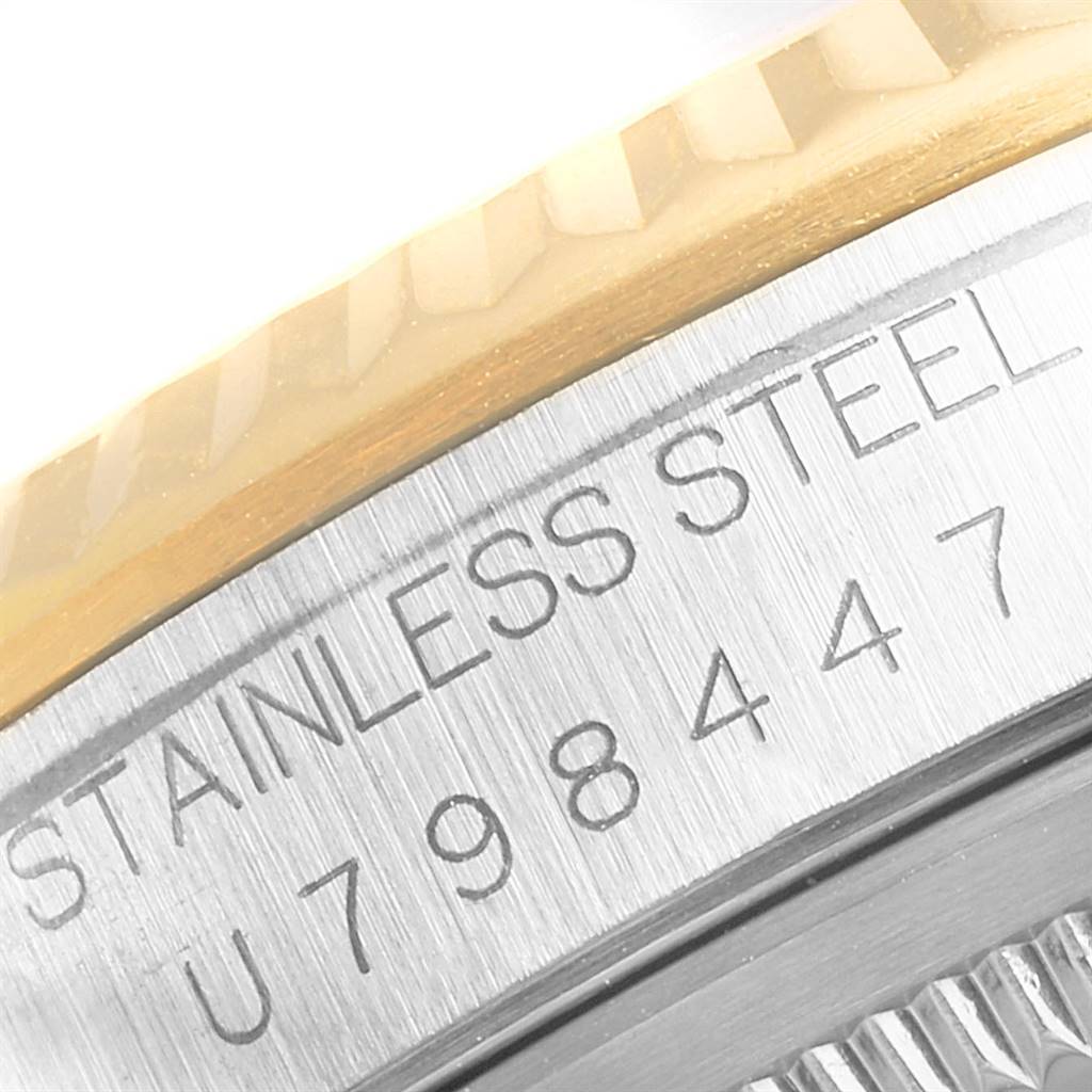 The image shows a close-up of the serial number and "STAINLESS STEEL" engraving on the case of a Rolex Datejust 16233 Men
s Steel and Gold (two tone) Champagne Dial 16233 Men
s Steel and Gold (two tone) Champagne Dial watch.
