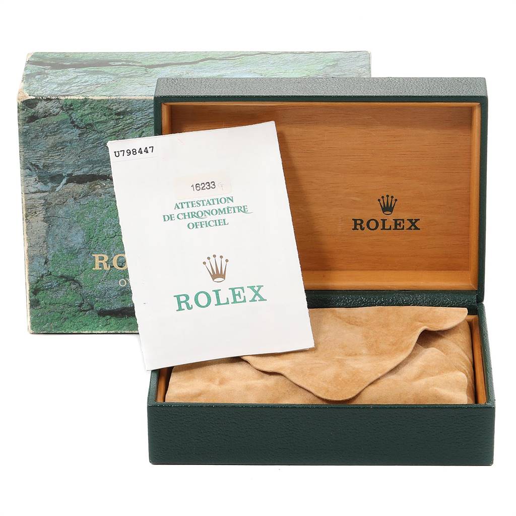 The image shows a Rolex Datejust 16233 Men
s Steel and Gold (two tone) Champagne Dial 16233 Men
s Steel and Gold (two tone) Champagne Dial watch box, its certificate, and a suede pouch, viewed from the front.
