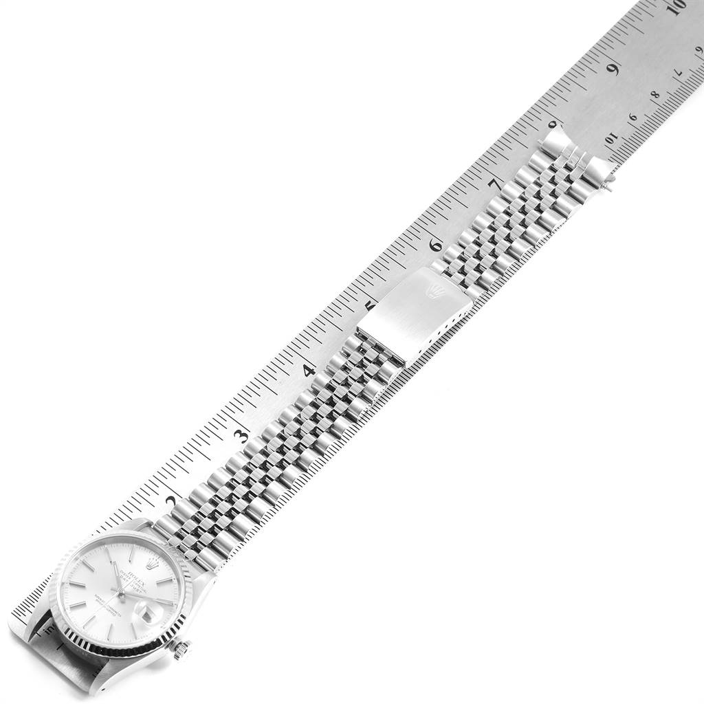 The image shows a Rolex Datejust 16234 Men's Stainless Steel Silver Dial 16234 Men's Stainless Steel Silver Dial watch laid flat alongside a ruler, focusing on its band and clasp.