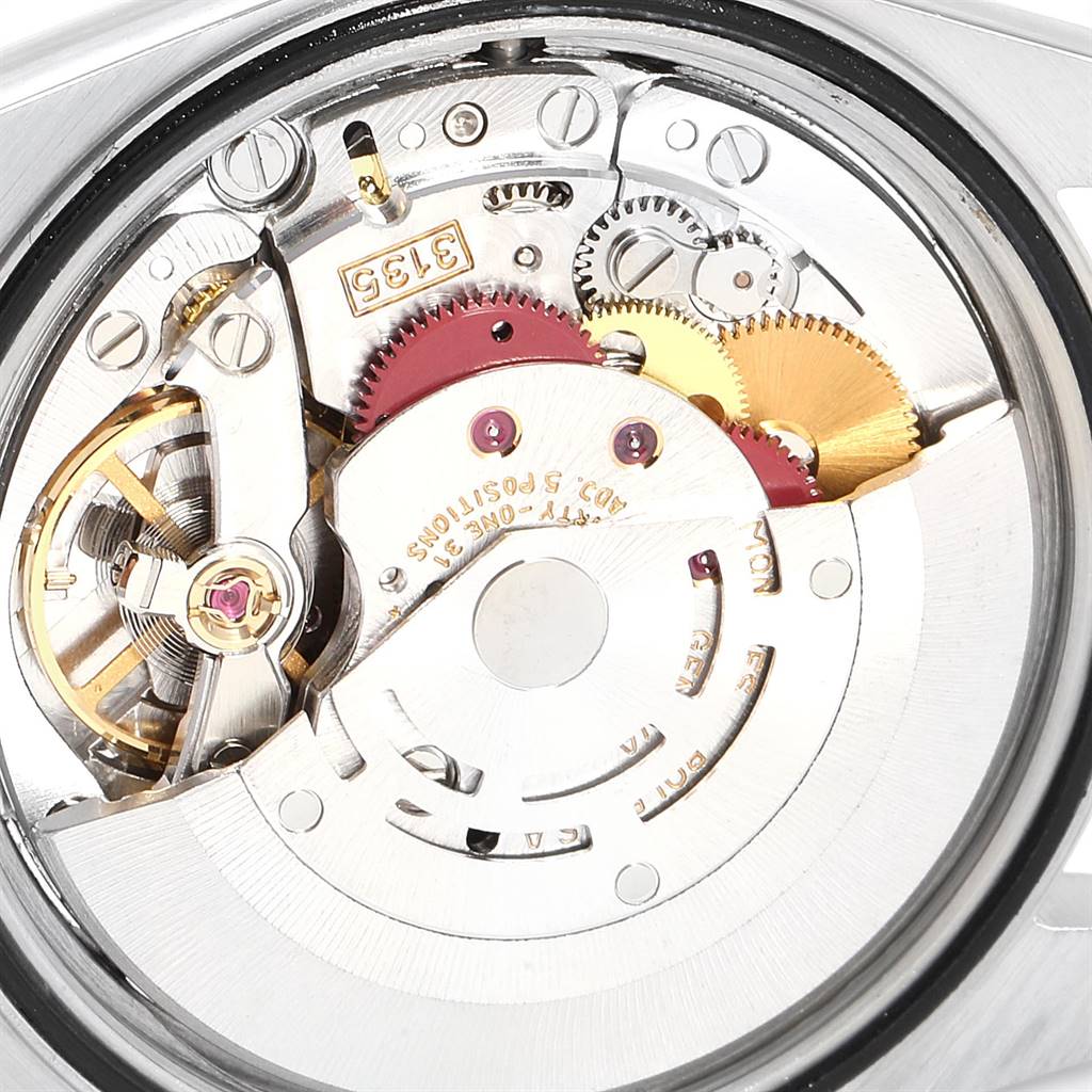The image shows a close-up view of the movement mechanism of a Rolex Datejust 16234 Men's Stainless Steel Silver Dial 16234 Men's Stainless Steel Silver Dial watch, highlighting its intricate gears and components.