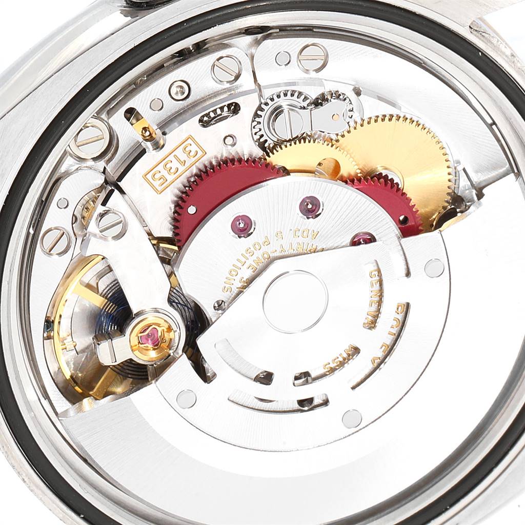 The image shows the movement mechanism of a Rolex Datejust 116234 Men's Stainless Steel Mother of Pearl Dial 116234 Men's Stainless Steel Mother of Pearl Dial watch from the back, revealing gears and intricate mechanical parts.