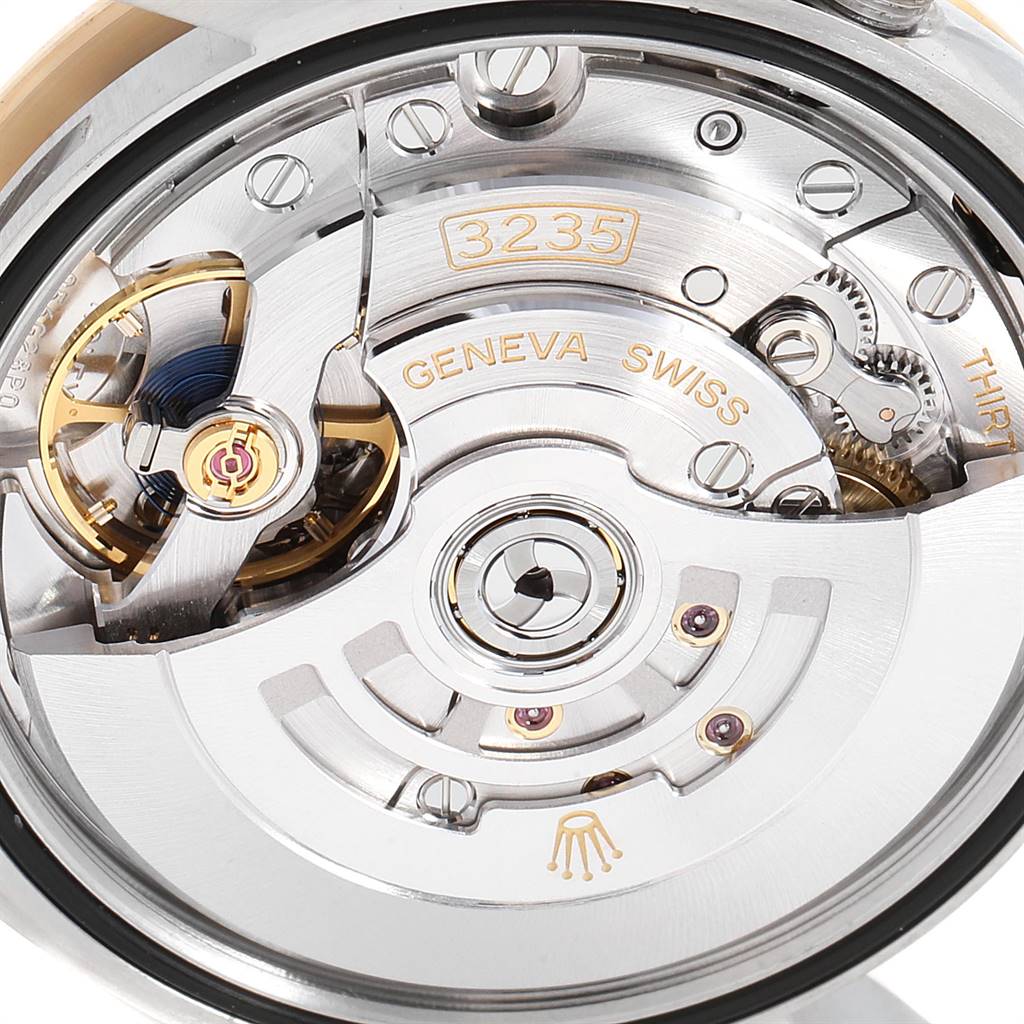 This image shows the intricate movement and mechanical parts inside a Rolex Datejust 126233 Men's Steel and Gold (two tone) Mother of Pearl Dial 126233 Men's Steel and Gold (two tone) Mother of Pearl Dial model watch.