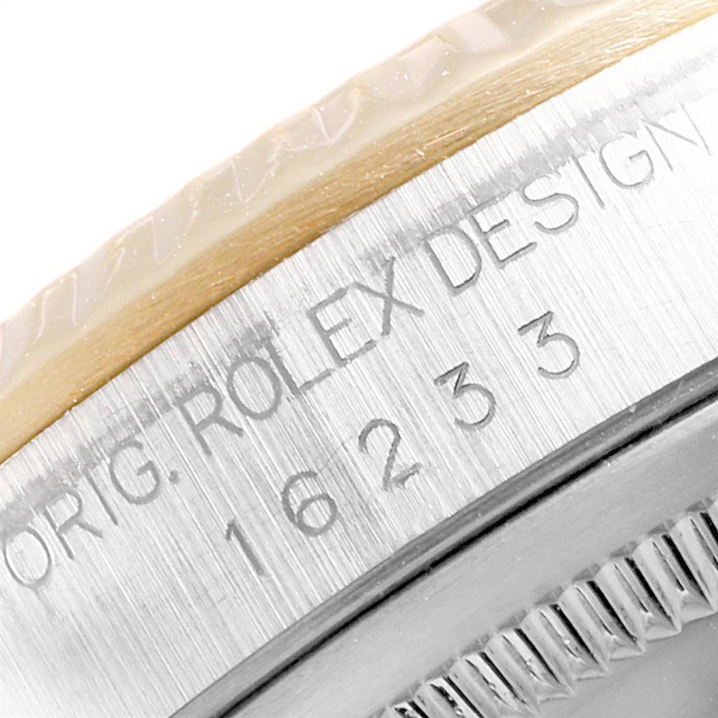 This close-up image of the Rolex Datejust 16233 Men's Steel and Gold (two tone) White Dial 16233 Men's Steel and Gold (two tone) White Dial watch highlights the engraved side of the case, showing the model number and brand inscription.