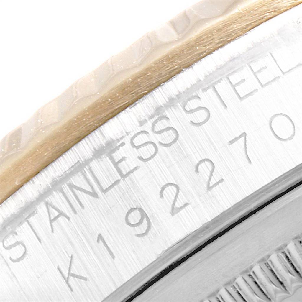 The image shows a close-up of the stainless steel case back and part of the bezel of a Rolex Datejust 16233 Men's Steel and Gold (two tone) White Dial 16233 Men's Steel and Gold (two tone) White Dial watch.