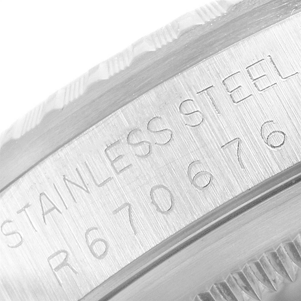 The image shows a close-up of the Rolex Datejust 16220 Men's Stainless Steel Silver Dial 16220 Men's Stainless Steel Silver Dial watch's stainless steel case with engraved text and part of the bezel.