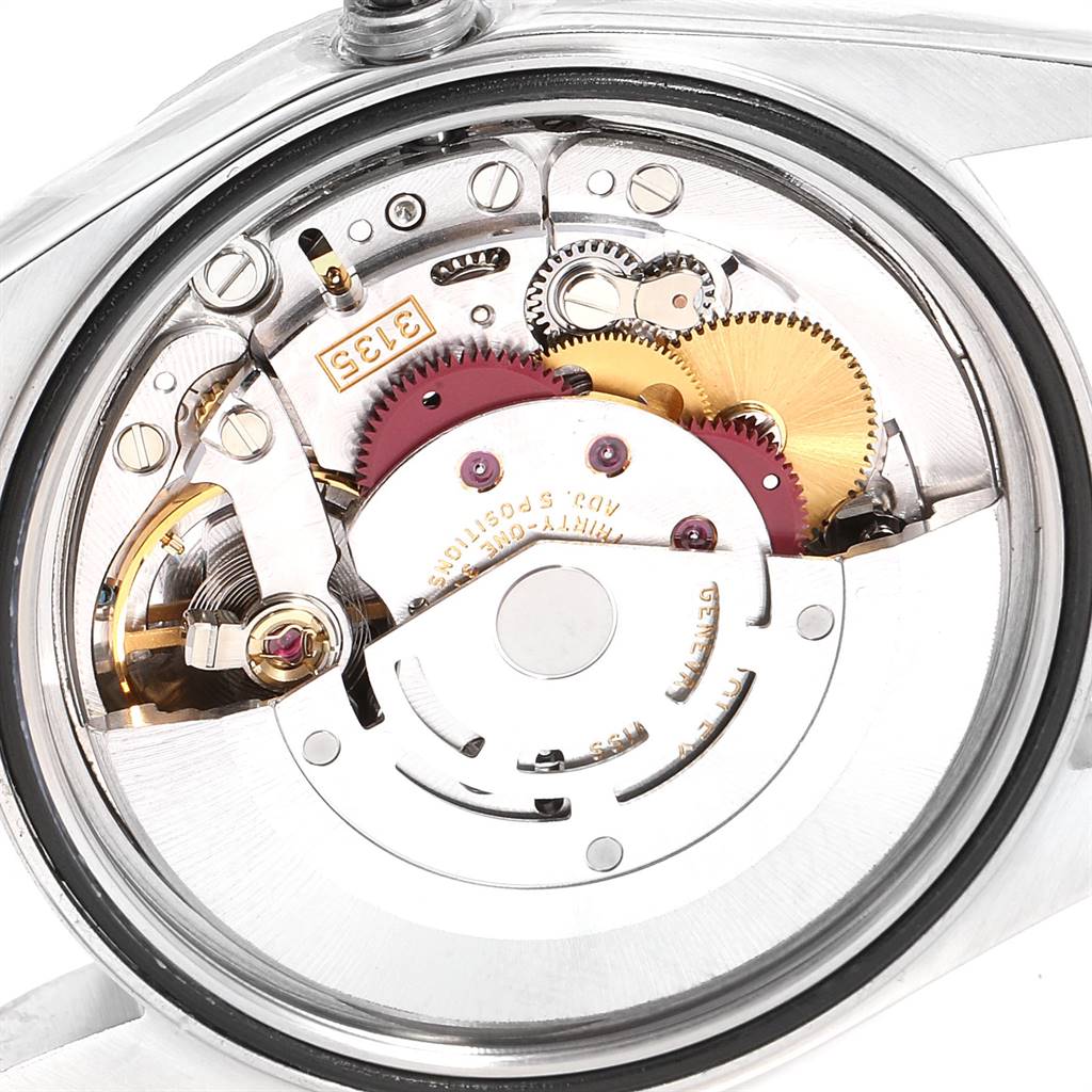 The image shows the intricate internal mechanism of a Rolex Datejust 16220 Men's Stainless Steel White Dial 16220 Men's Stainless Steel White Dial, highlighting gears and components from a rear view.
