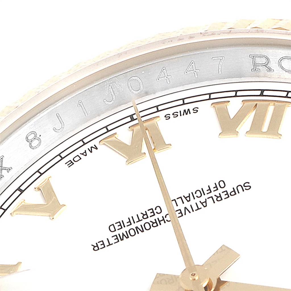 This close-up image of a Rolex Datejust 116233 Men's Stainless Steel White Dial 116233 Men's Stainless Steel White Dial watch shows the face with Roman numerals, part of the bezel, and serial number engraving.