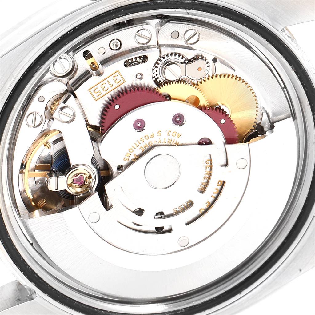 The image shows a top-down view of the internal movement mechanism of a Rolex Datejust 116233 Men's Stainless Steel White Dial 116233 Men's Stainless Steel White Dial watch, highlighting gears and components.