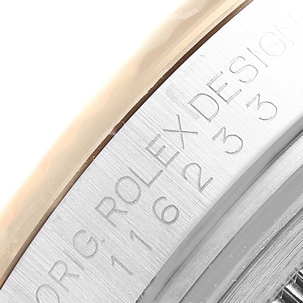The image shows a close-up of the engraved bezel and edge of the case of a Rolex Datejust 116233 Men's Stainless Steel White Dial 116233 Men's Stainless Steel White Dial watch.